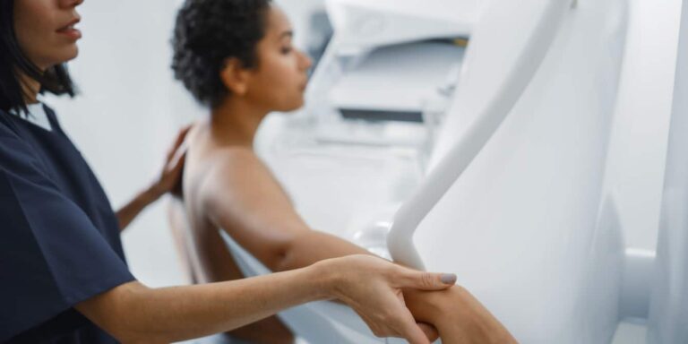 Female Doctor helping Mammogram Procedure Topless Latin Female Patient