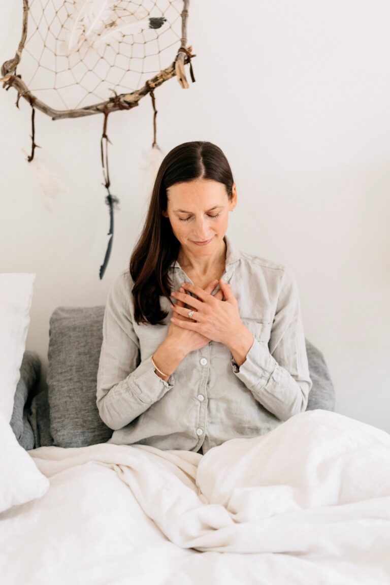 woman meditating in bed