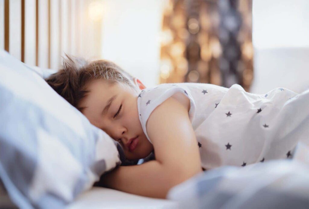 cute boy sleeping on bed with morning light lovely child get deep sleep while taking a nap kid relax