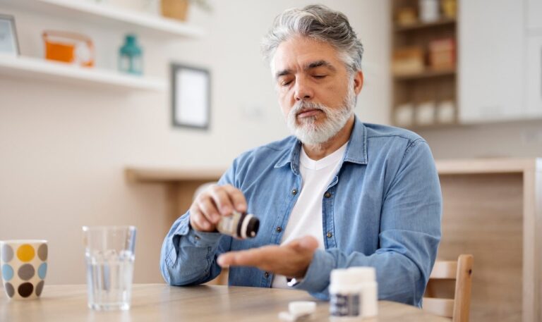 older man taking pills